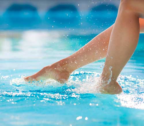 Feet splashing in the pool